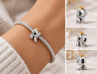 Silver R letter crown charm worn on a snake-chain charm bracelet, with close-up views